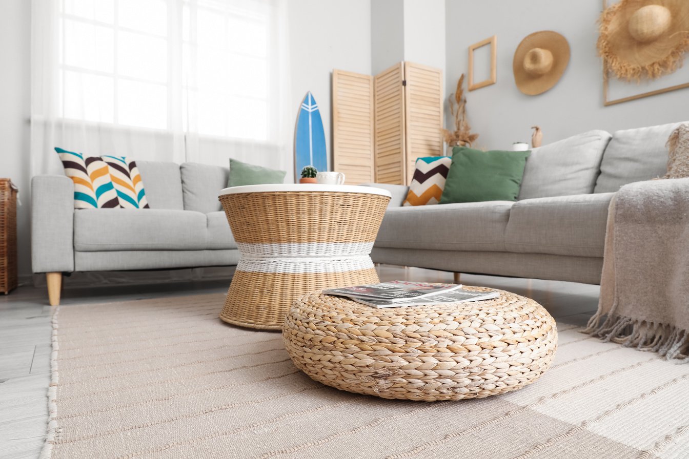 Interior of Light Living Room with Surfboard, Table and Sofas